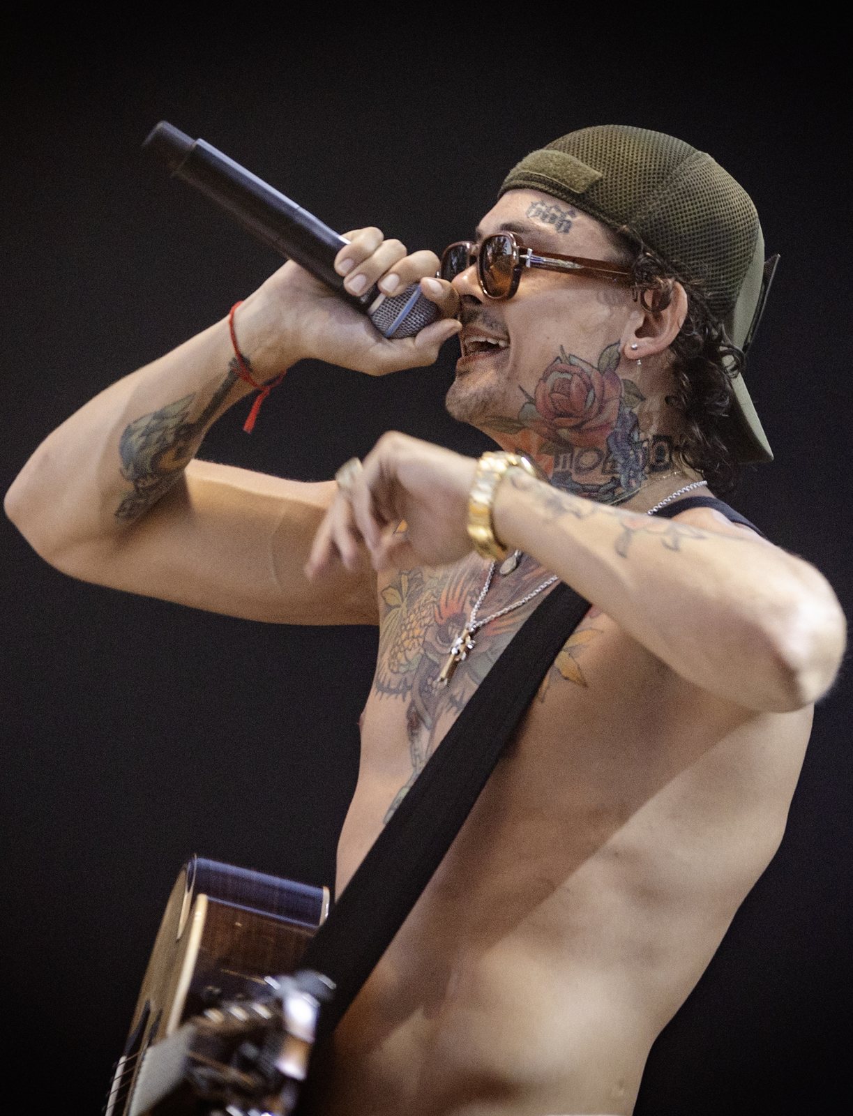 Morgenshtern singing into a microphone on stage in Israel, 2024
