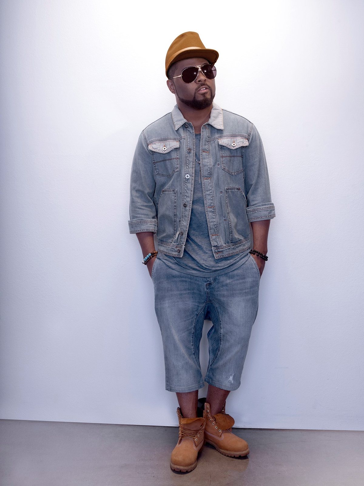 Musiq Soulchild in a 2016 portrait wearing a denim jacket, hat and sunglasses