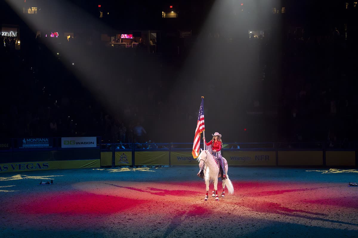 Buy National Finals Rodeo tickets on StubOrder Flag carried on horseback in the arena at the National Finals Rodeo