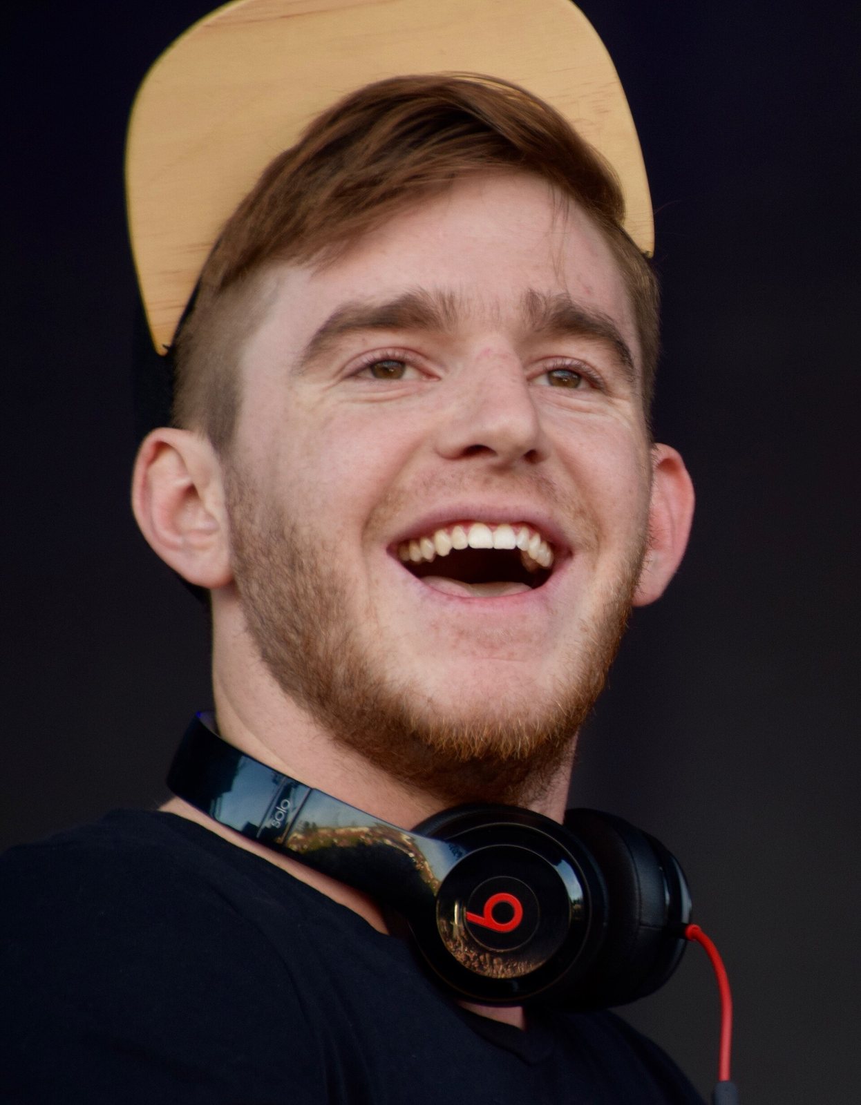 Nghtmre smiling on stage at St. Lawrence University's Springfest concert, New York, April 2016