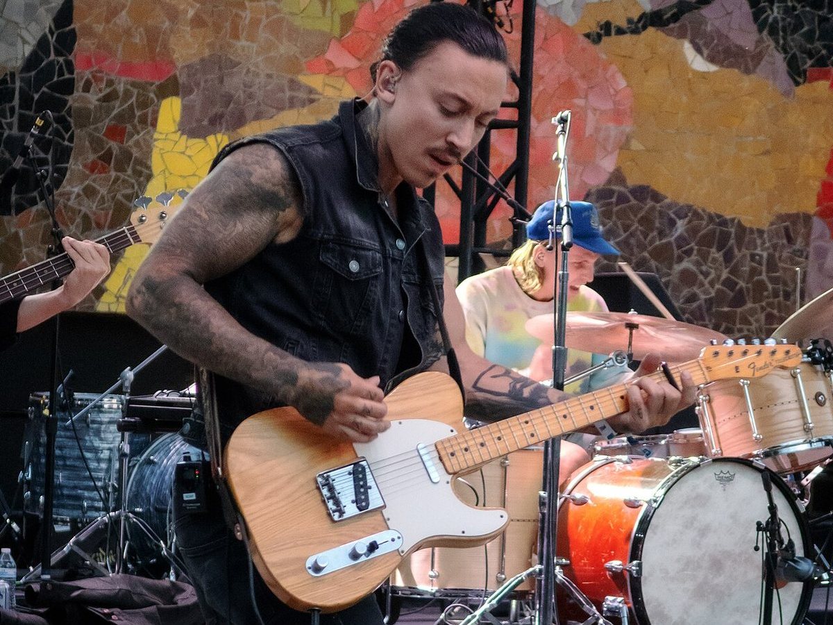 Buy Noah Gundersen tickets on StubOrder Noah Gundersen playing electric guitar with his band at Bumbershoot, Seattle, 2018