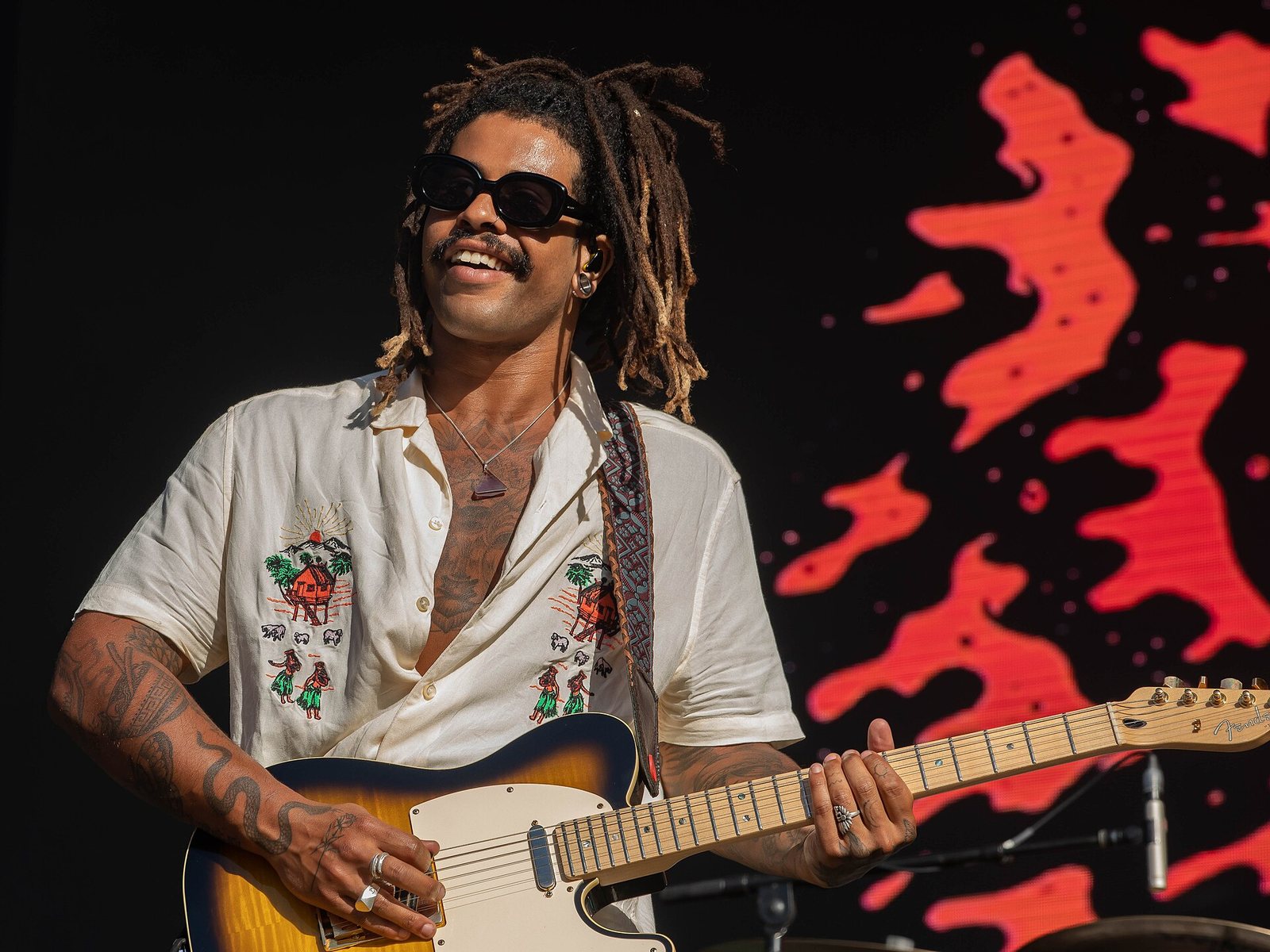 Ocean Alley singer Baden Donegal playing guitar on stage at Falls Festival, December 2018