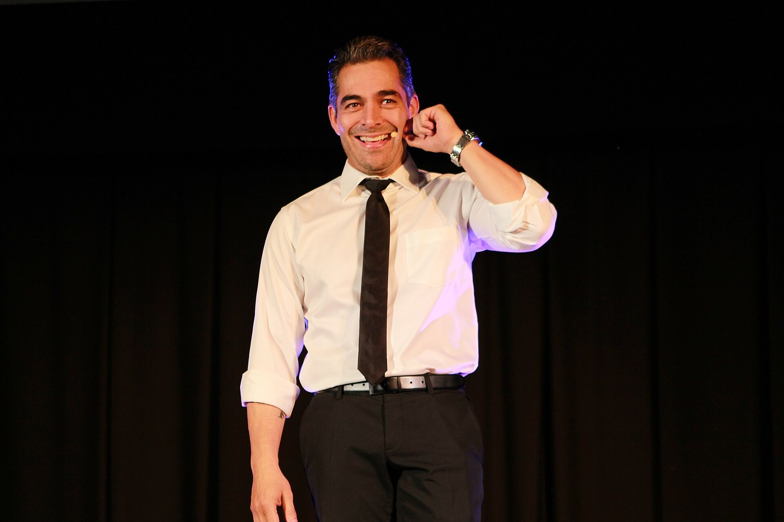 Omar Chaparro on stage with a headset microphone at TEDx Tijuana, 2018
