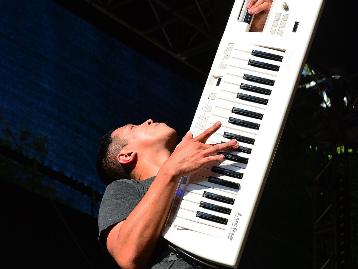 Buy Passafire tickets on StubOrder Passafire keyboardist playing a keytar on stage at the Wilwarin Festival in Germany, 2015
