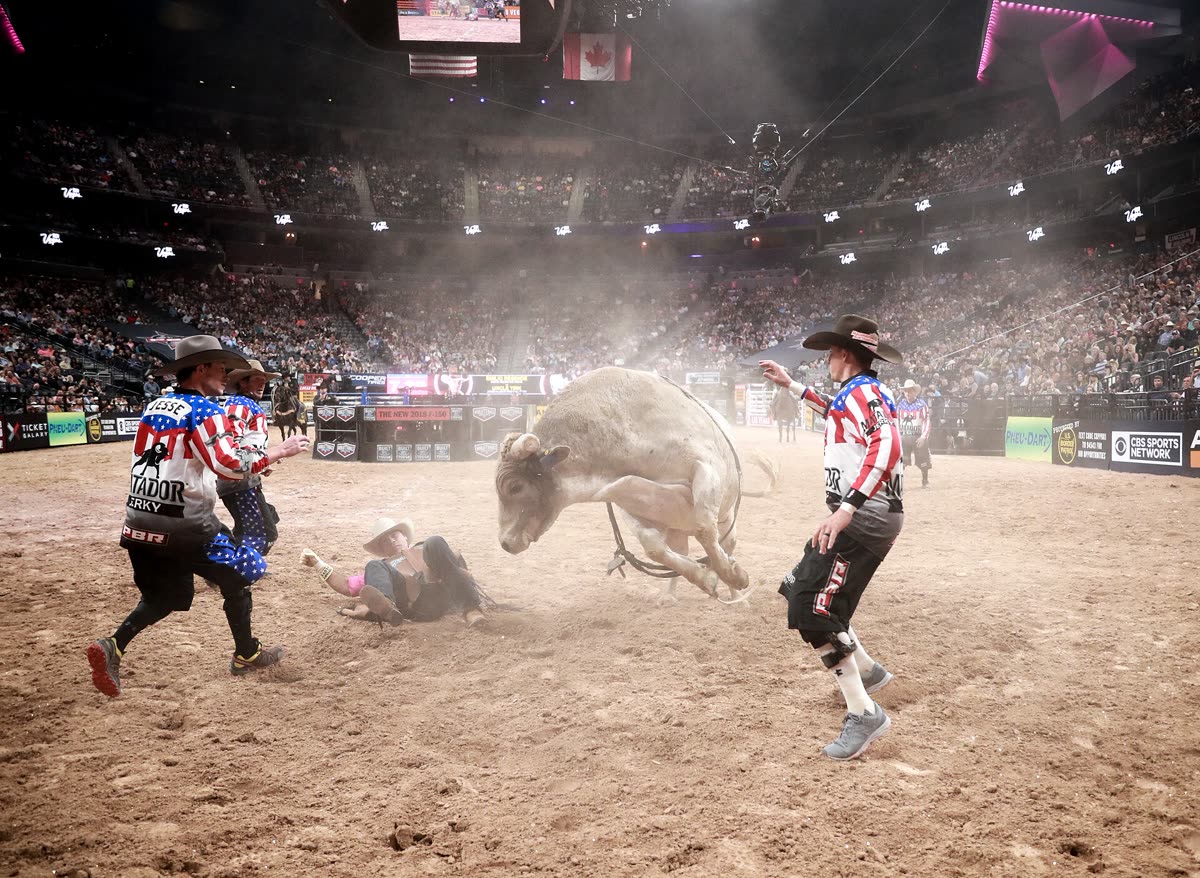 Buy PBR World Finals tickets on StubOrder Rodeo clowns shield a dismounted rider at the 2017 PBR World Finals