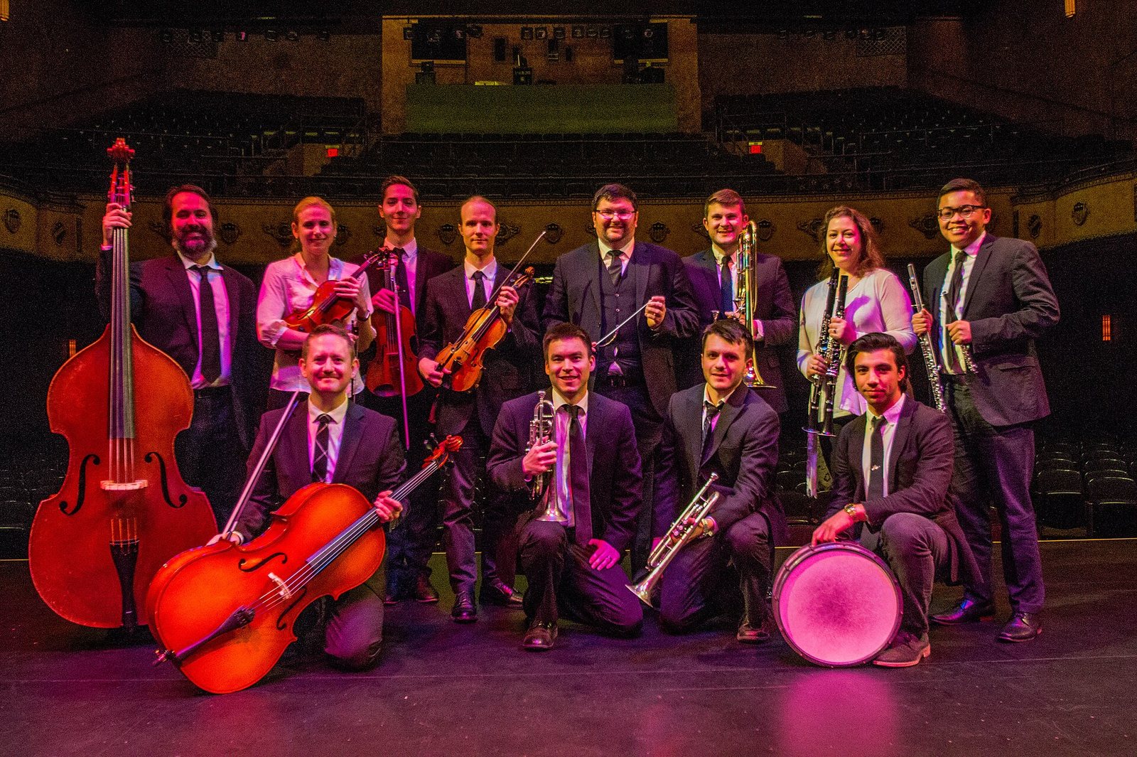 Peacherine Ragtime Society Orchestra posing with instruments on the Gillioz Theatre stage, Springfield, Missouri, 2020