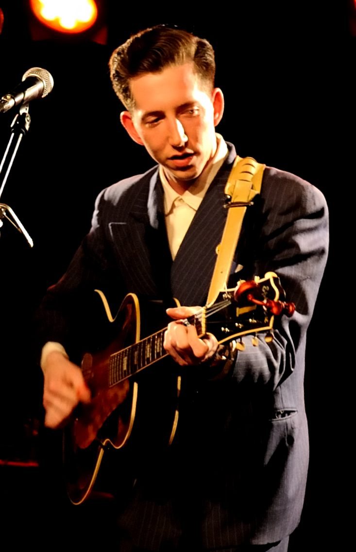 Pokey LaFarge playing guitar on stage in Reutlingen, Germany, 2012