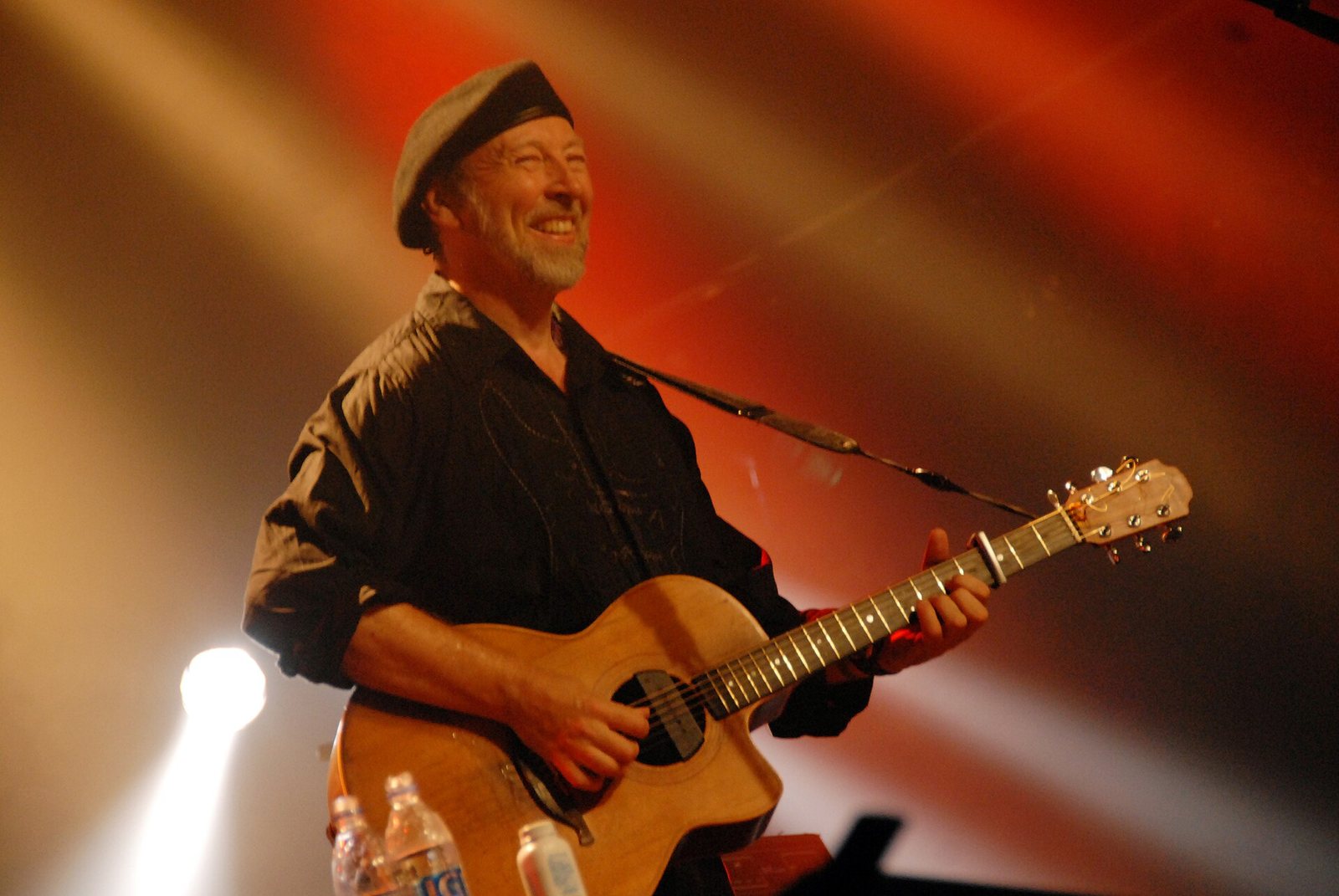 Richard Thompson playing acoustic guitar on stage at the Cambridge Folk Festival, 2006
