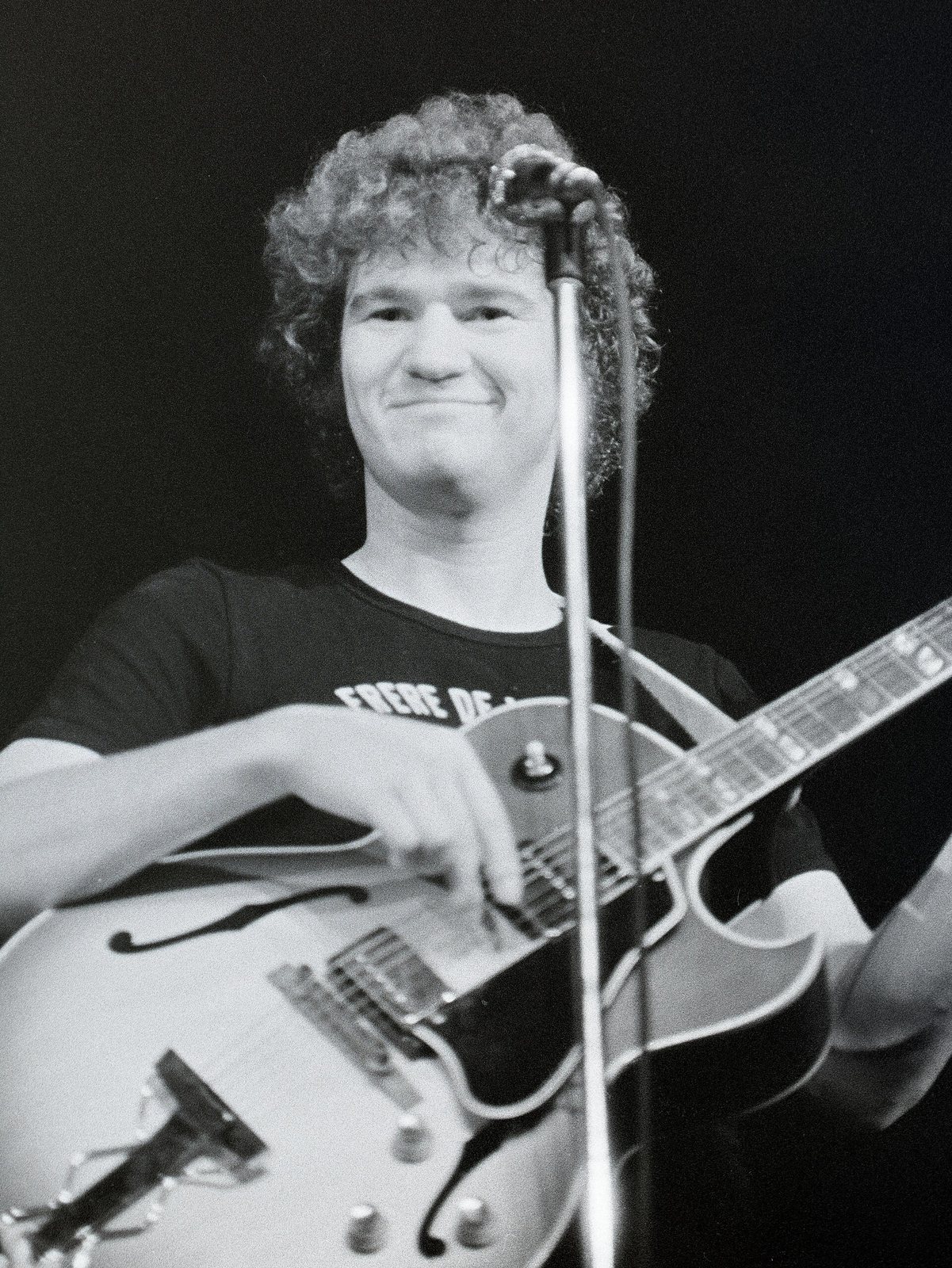 Robert Charlebois smiling on stage with an electric guitar at Maisonneuve College, Montreal, 1972