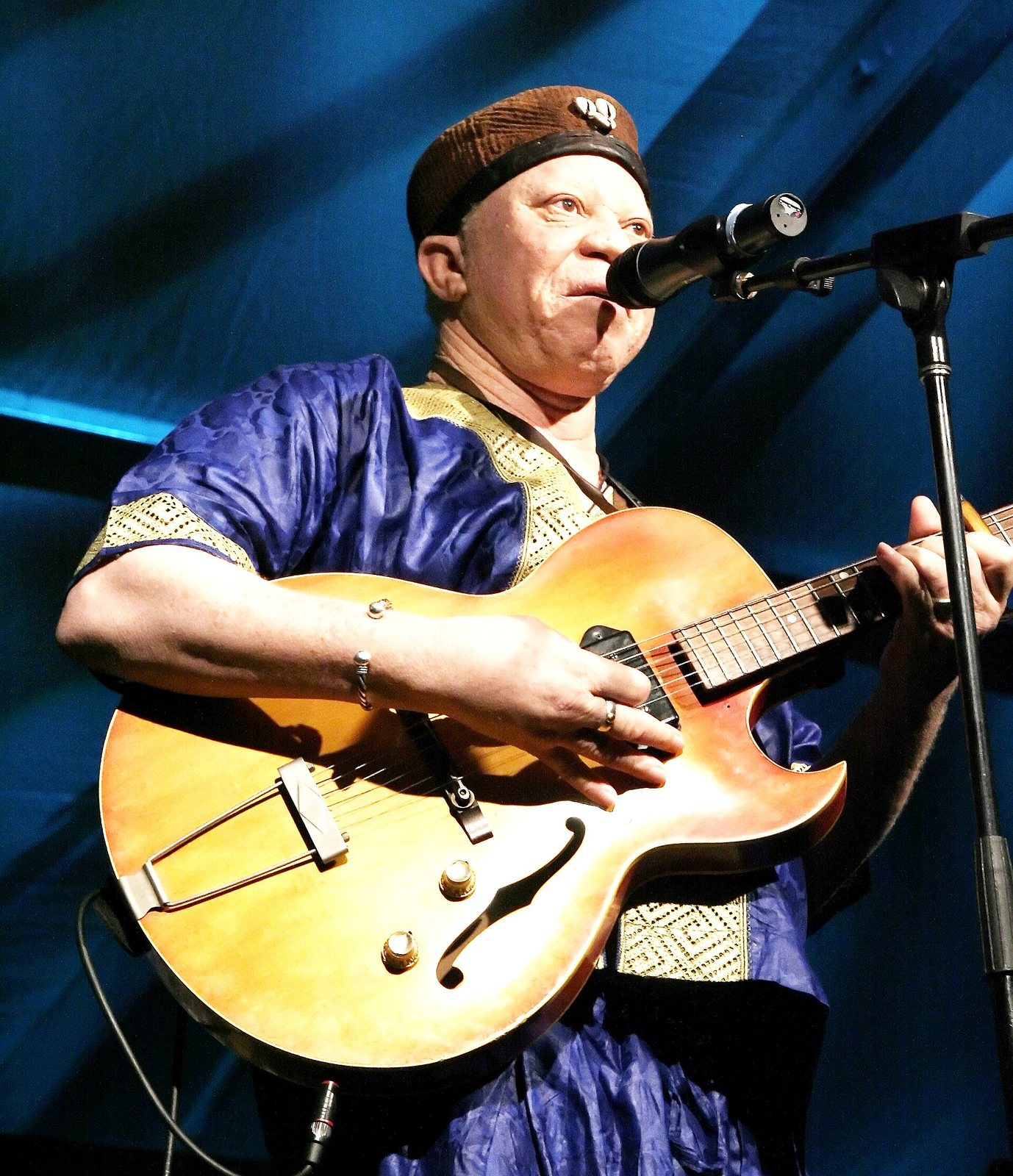 Salif Keita singing and playing guitar on stage in Toronto, June 2008