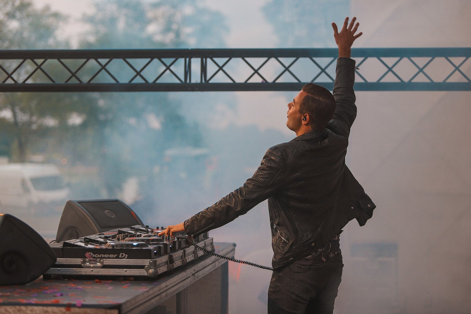 Sam Feldt DJing on stage with one arm raised during a 2019 performance