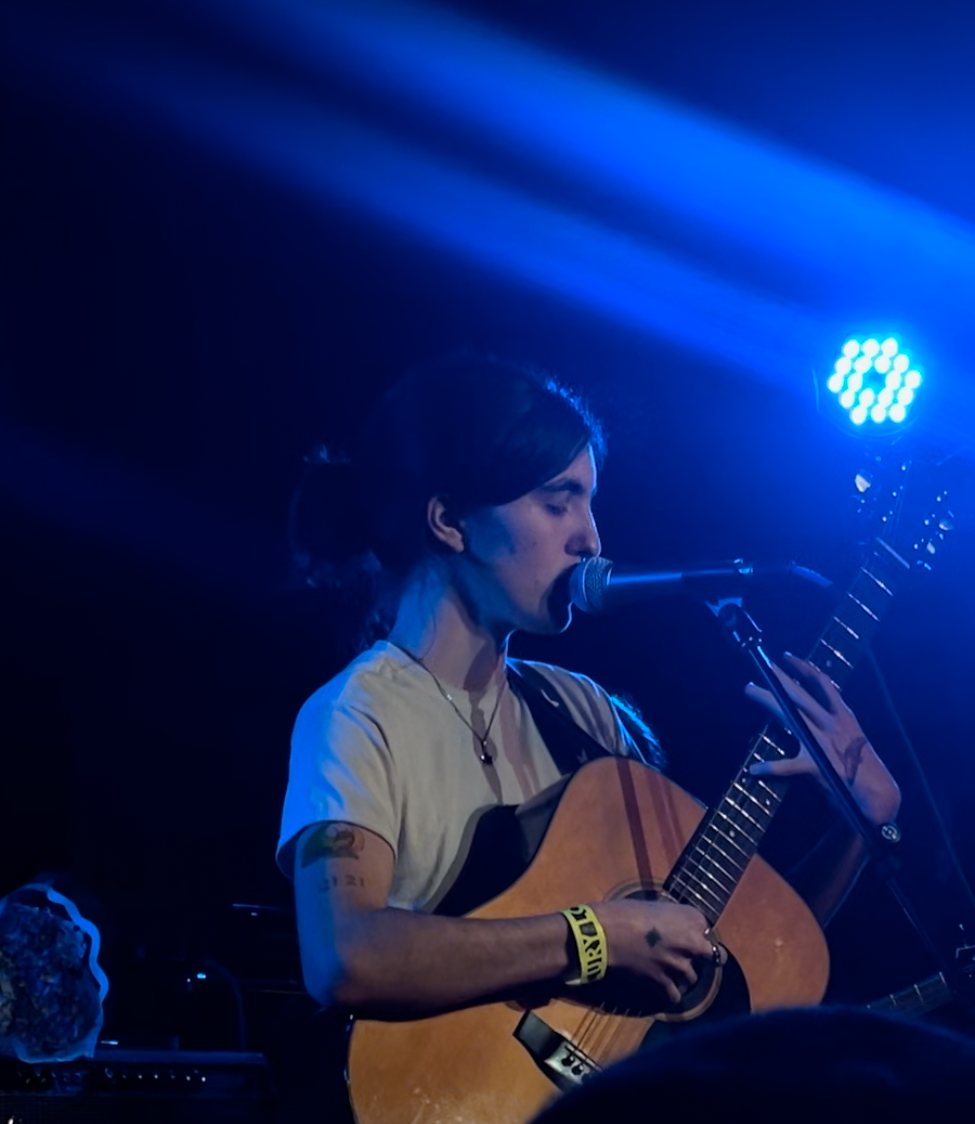 Searows singing and playing acoustic guitar at the Mercury Lounge, New York City, 2024