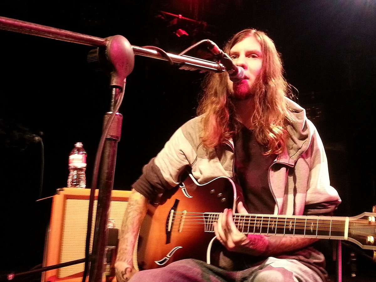 Smile Empty Soul singer Sean Danielsen performing with an acoustic electric guitar, 2015