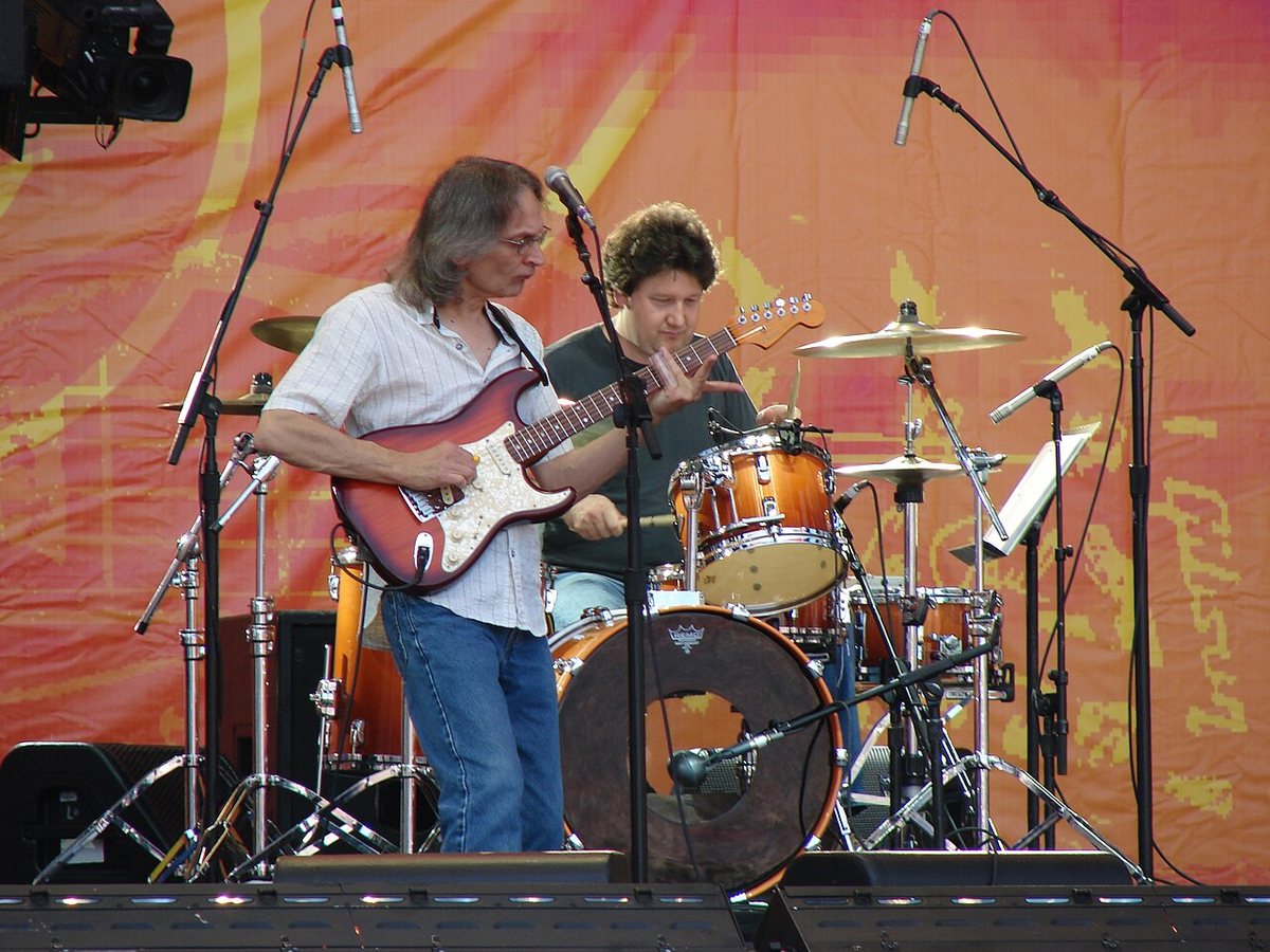 Sonny Landreth playing guitar on stage with a drummer at the Crossroads Guitar Festival, 2010