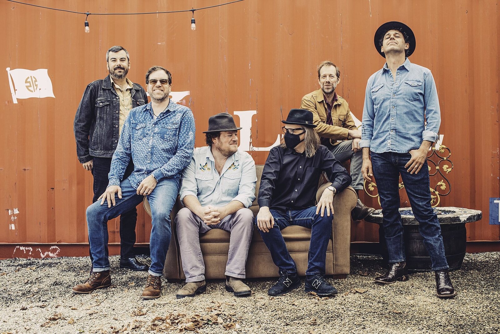 Steep Canyon Rangers posing in front of an orange shipping container, 2022