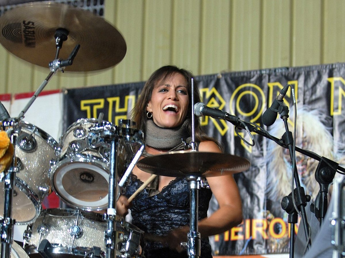 Linda McDonald drumming with The Iron Maidens at Contingency Operating Base Speicher, Iraq, July 2008