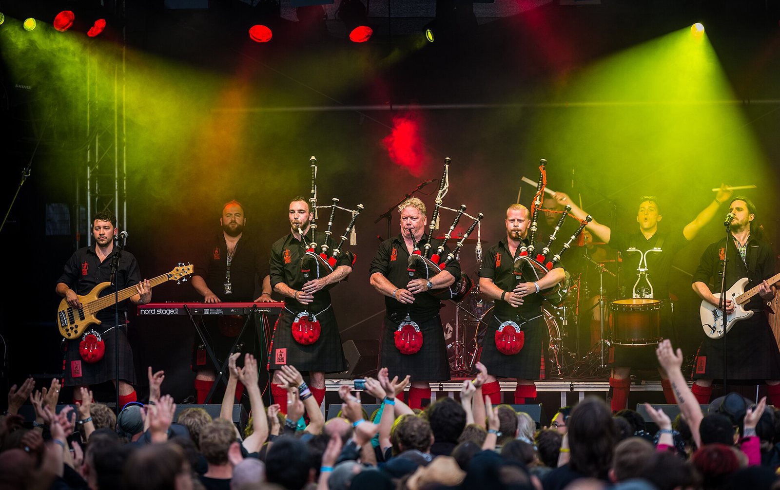 Red Hot Chilli Pipers performing in kilts with bagpipes, guitars and drums at Wacken Open Air, Germany, 2016