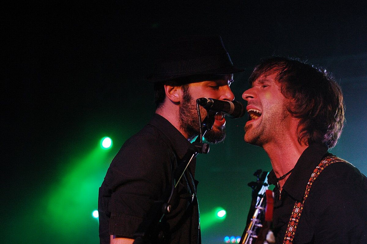 Two members of The Trews singing into one microphone at the University of New Brunswick, September 2008