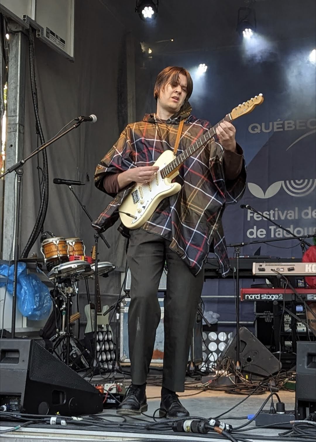 Thierry Larose playing guitar on stage at the Festival de la chanson de Tadoussac, 2022