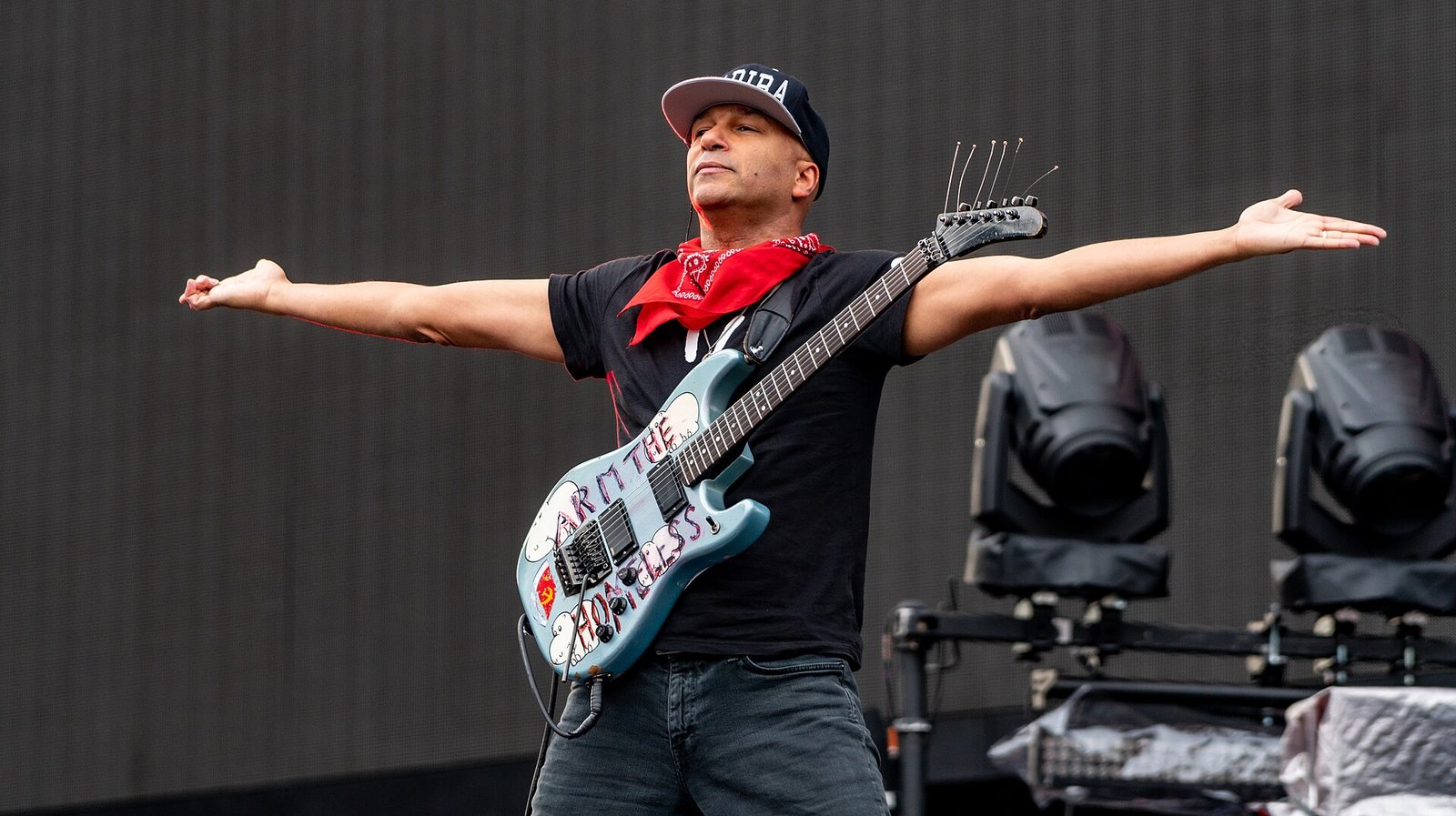 Tom Morello on stage with arms outstretched, supporting Muse at Ashton Gate, Bristol, June 2019