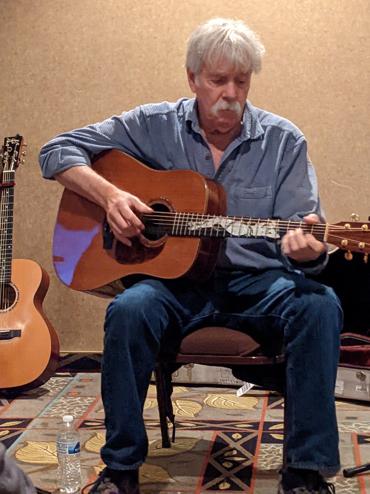 Tom Rush playing an acoustic guitar, September 2022