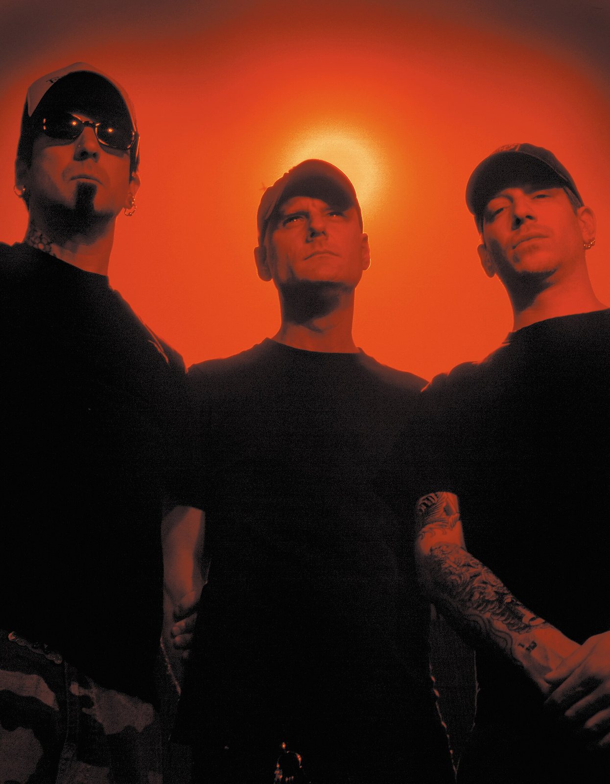The three members of Unsane in a red-toned 2005 band portrait