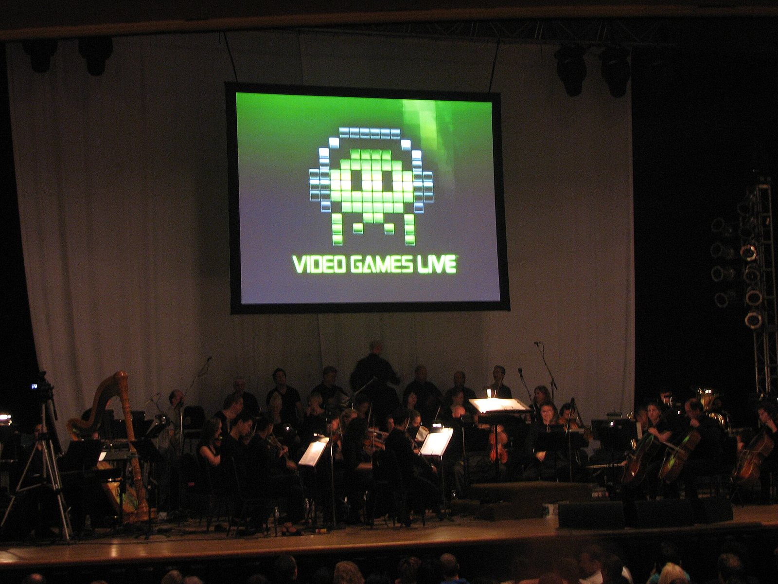 Video Games Live concert with an orchestra under the show's pixel logo on screen, Toronto, 2006