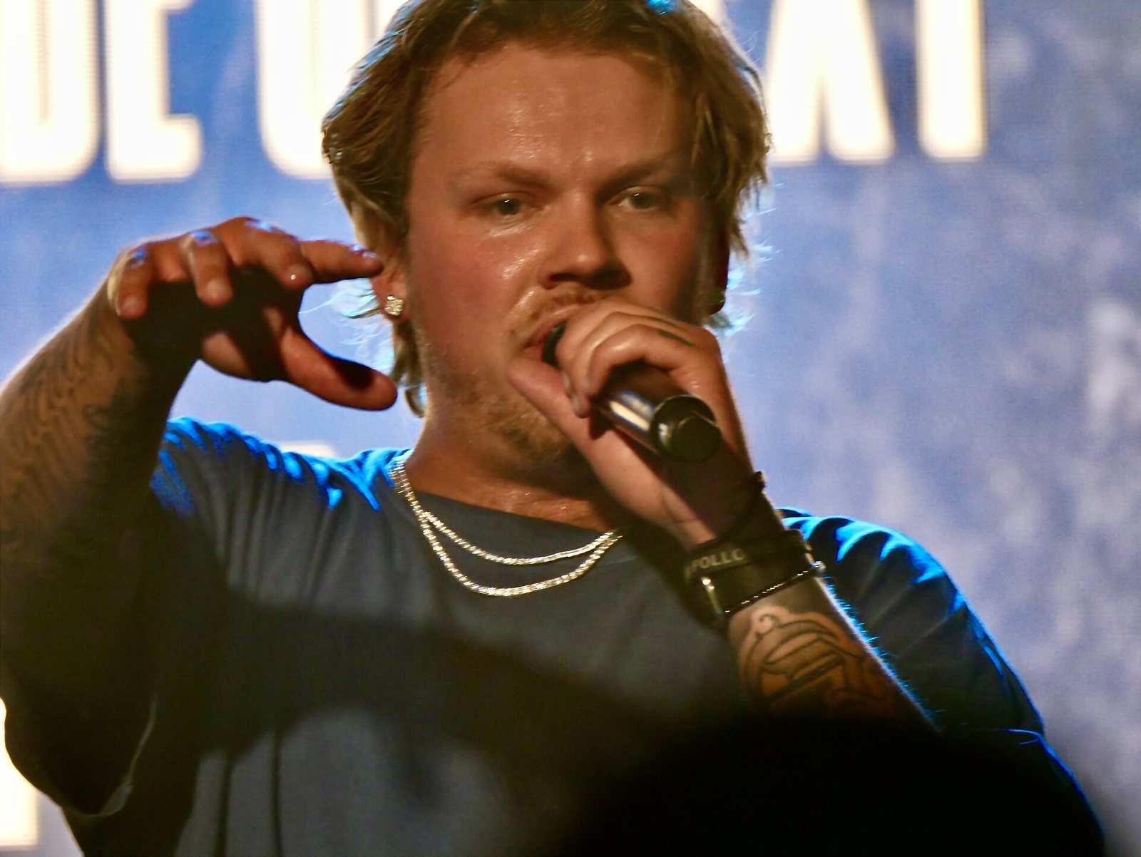 Zauntee rapping into a microphone on stage at Holy Smoke! 2025, Nashville