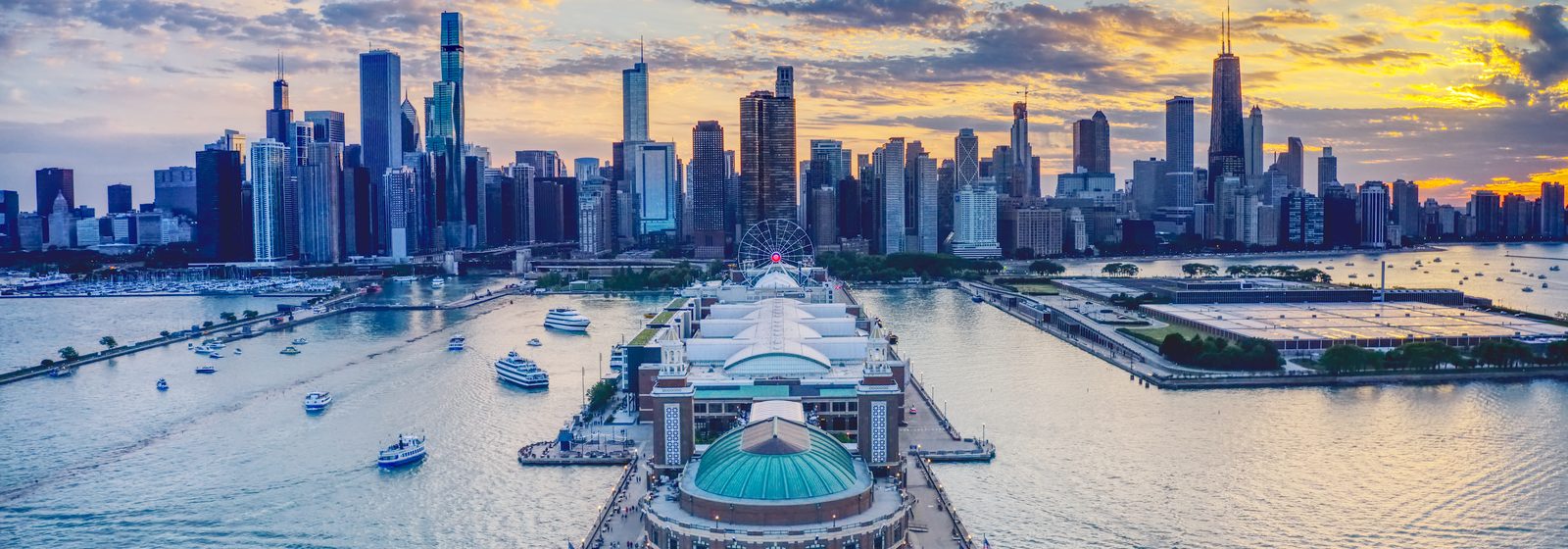 Aerial view of Chicago's Navy Pier and skyline with boats at sunset