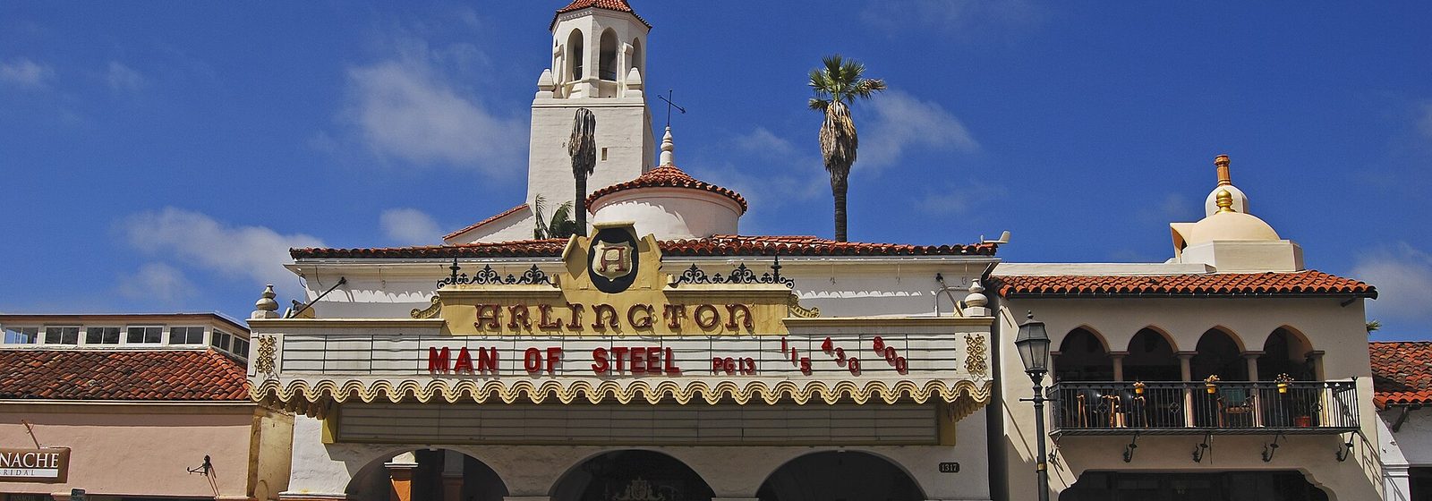Street-level view of the Arlington Theatre's Spanish Colonial Revival facade, marquee, and bell tower on State Street in Santa Barbara - Arlington Theatre tickets