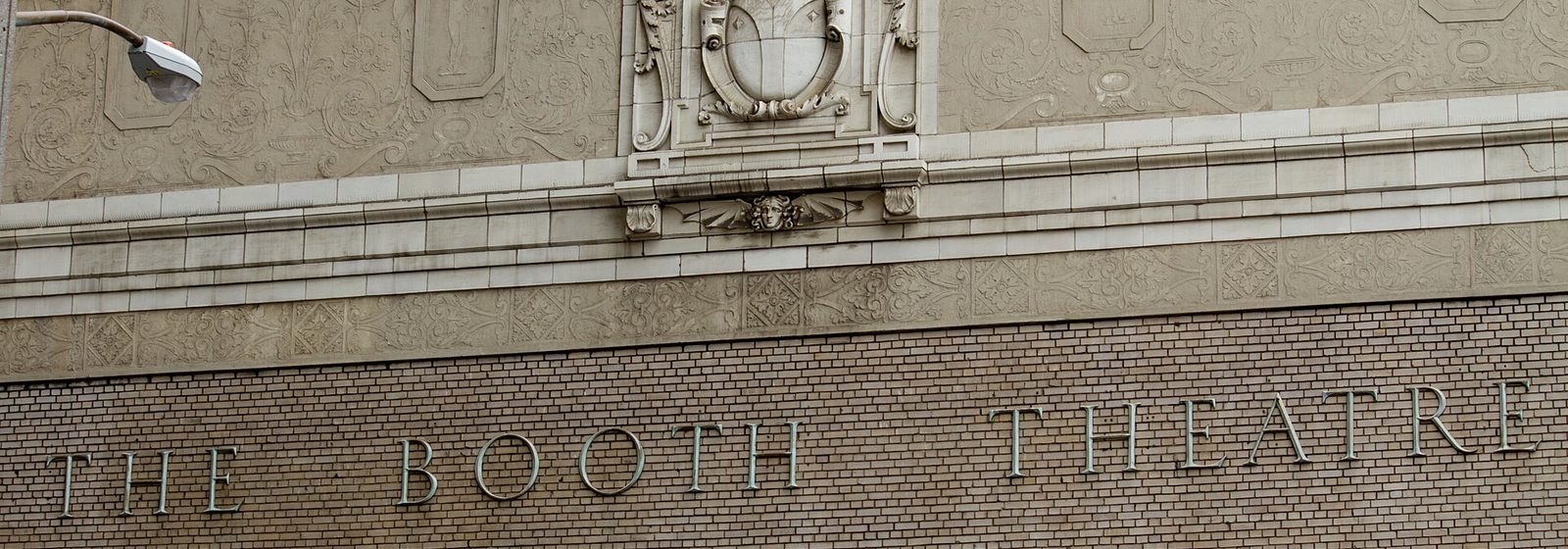 Street-level view of the Booth Theatre's exterior facade and marquee on West 45th Street in Manhattan, New York - Booth Theatre tickets