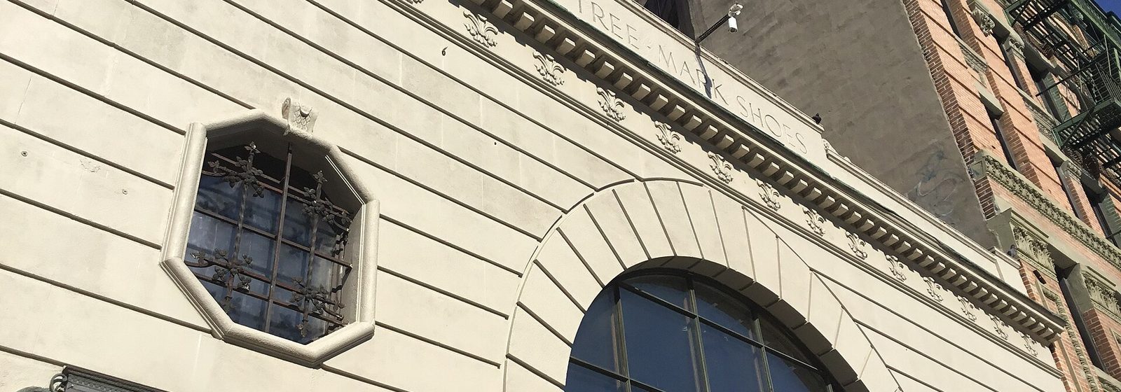 Stone facade of the Bowery Ballroom in Manhattan, New York, with its arched window and venue nameplate above the entrance - Bowery Ballroom tickets