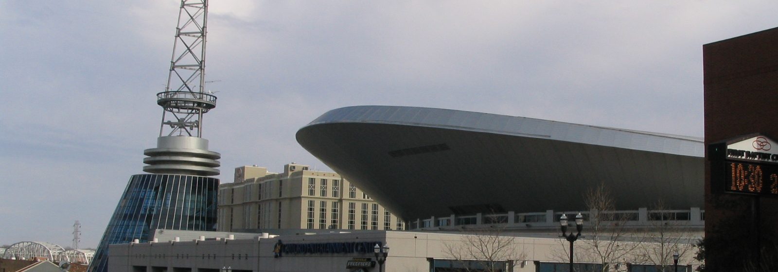 Street-level exterior view of Bridgestone Arena's cantilevered roof and broadcast tower in downtown Nashville, Tennessee - Bridgestone Arena tickets