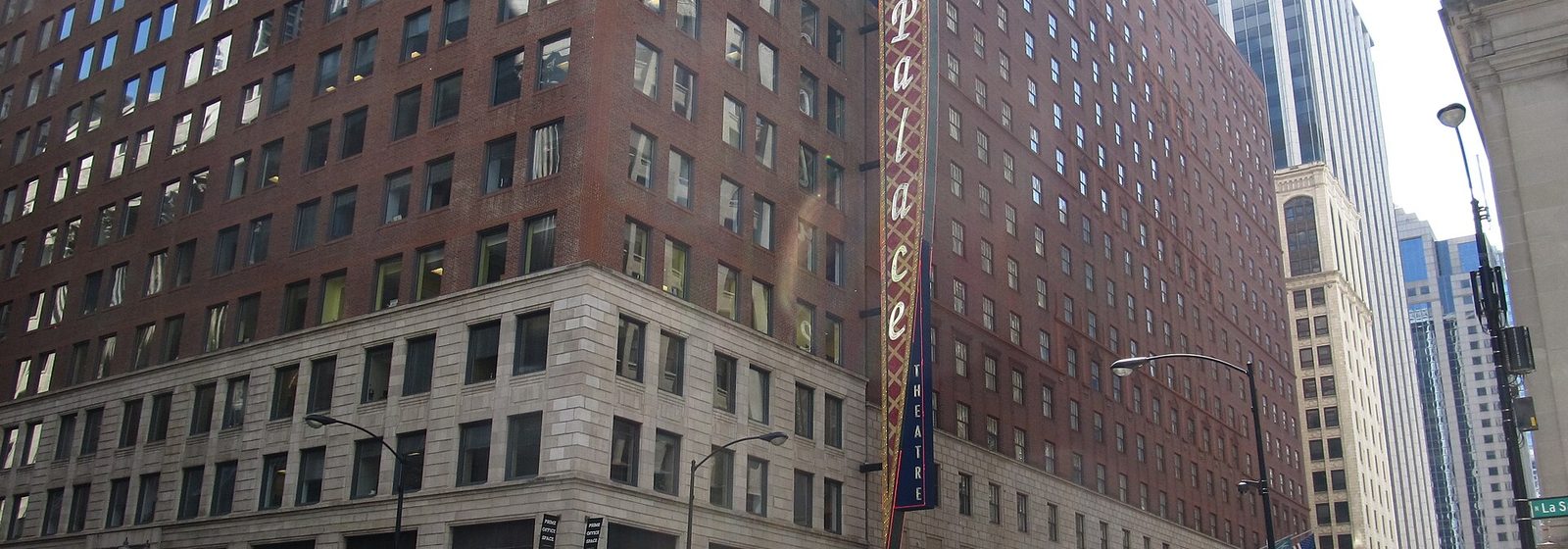 Street-level view of the Cadillac Palace Theatre's vertical Palace sign and marquee on West Randolph Street in Chicago's Loop - Cadillac Palace tickets