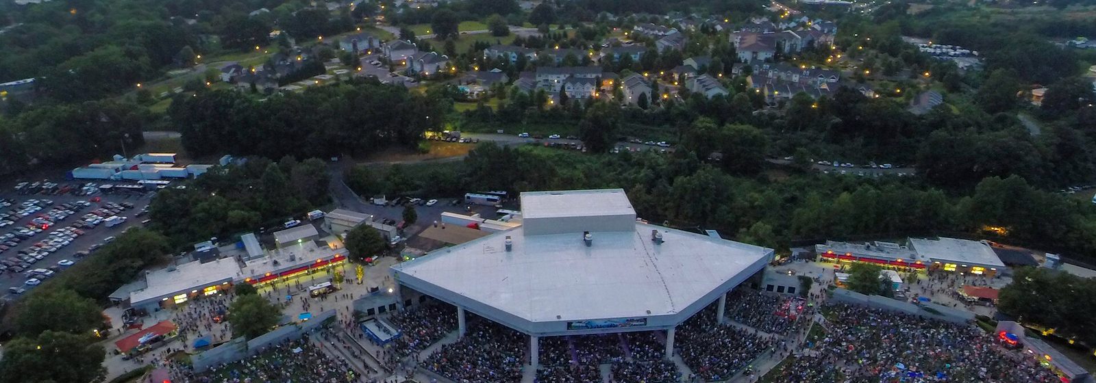 Aerial view of Cellairis Amphitheatre at Lakewood during a concert, with the downtown Atlanta skyline in the distance - Cellairis Amphitheatre at Lakewood tickets