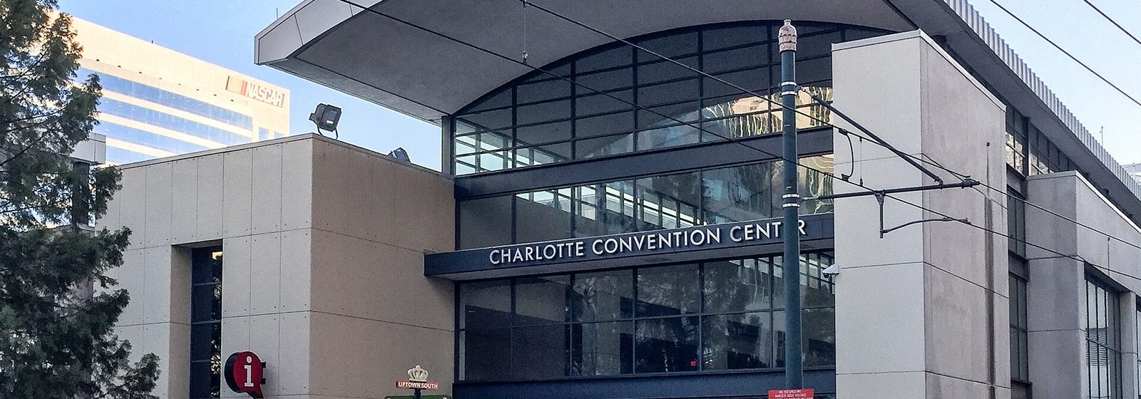 Street-level view of the arched glass main entrance of the Charlotte Convention Center in Uptown Charlotte, North Carolina - Charlotte Convention Center tickets