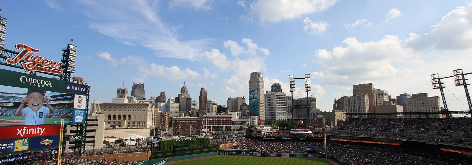 View from the upper deck of Comerica Park in Detroit showing the seating bowl, playing field, and the downtown Detroit skyline beyond the outfield - Comerica Park tickets