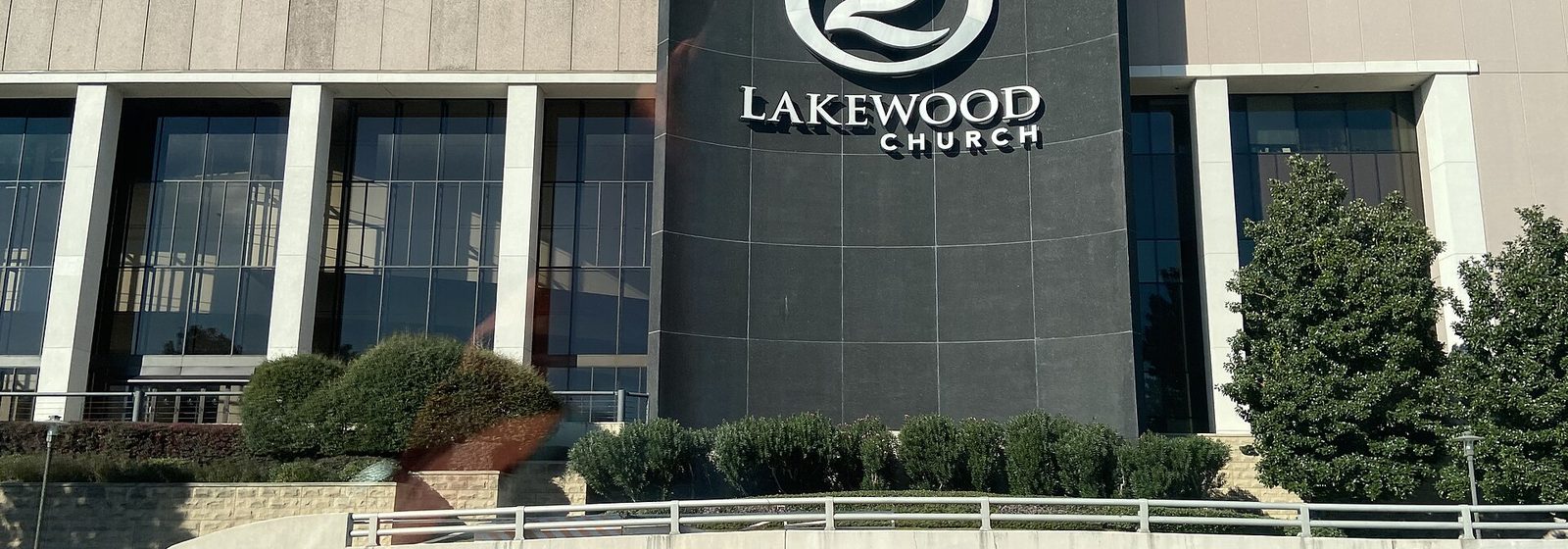 Exterior facade of the former Compaq Center in Houston, now Lakewood Church, with its curved entrance sign tower - Compaq Center tickets