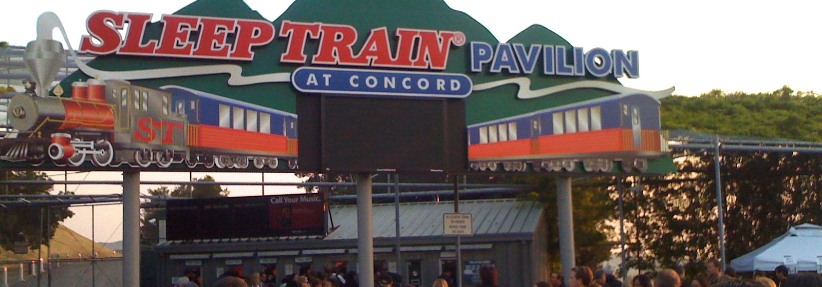 Entrance marquee and box office of the Concord Pavilion, signed under its former name Sleep Train Pavilion at Concord, as concertgoers arrive in Concord, California - Concord Pavilion tickets