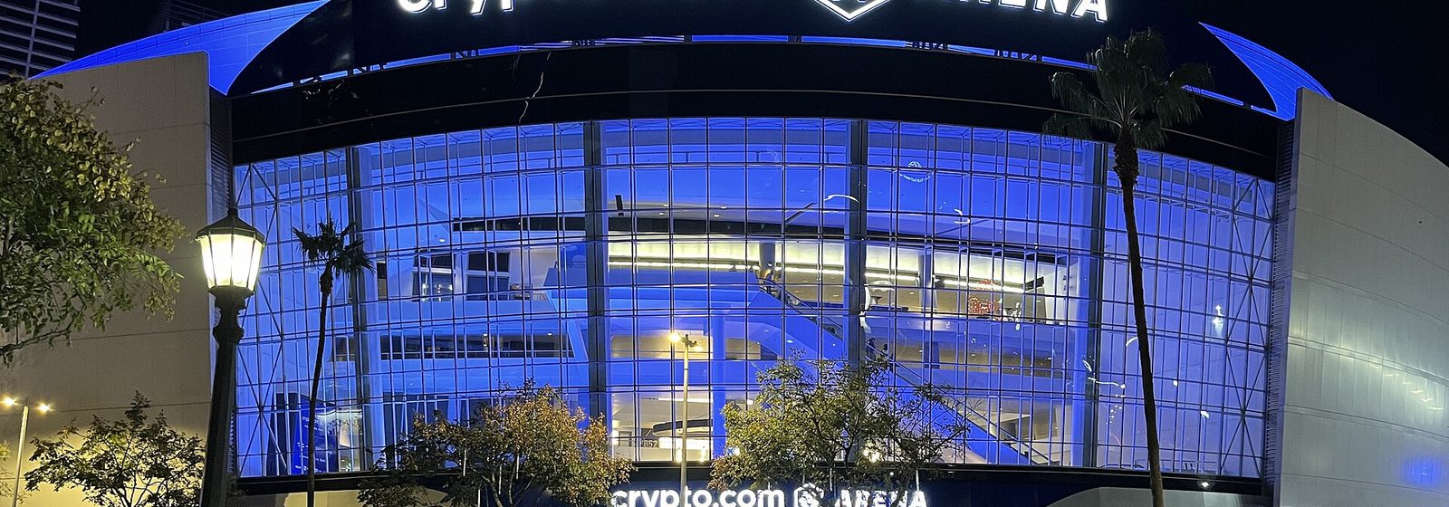 Airports near Crypto.com Arena Night view of the glass entrance facade of Crypto.com Arena in downtown Los Angeles with its illuminated signage - Crypto.com Arena tickets