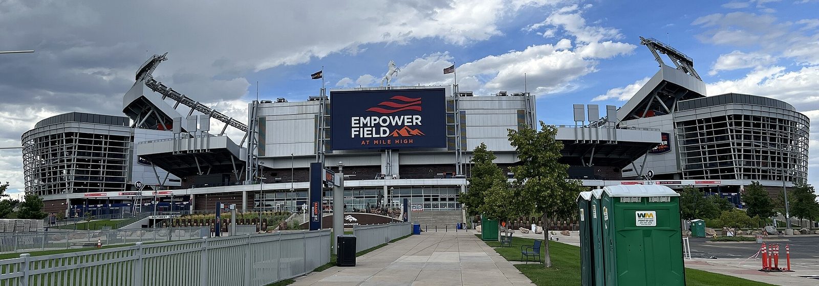 Airports near Empower Field At Mile High Street-level exterior view of Empower Field at Mile High in Denver, Colorado, showing the stadium facade with its signage and white bronco statue above the main entrance - Empower Field At Mile High tickets