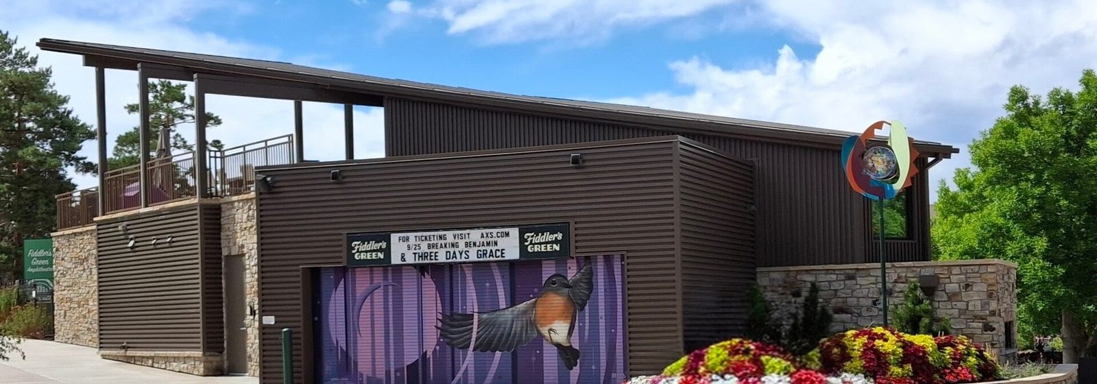 Box office and entrance building at Fiddler's Green Amphitheatre in Englewood, Colorado, with the venue's marquee signs - Fiddlers Green Amphitheatre tickets