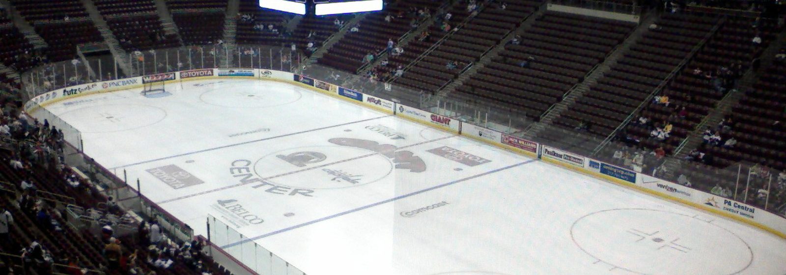 Wide interior view of the Giant Center arena bowl in Hershey, Pennsylvania, showing the ice rink, seating tiers, and center-hung scoreboard before a hockey game - Giant Center tickets