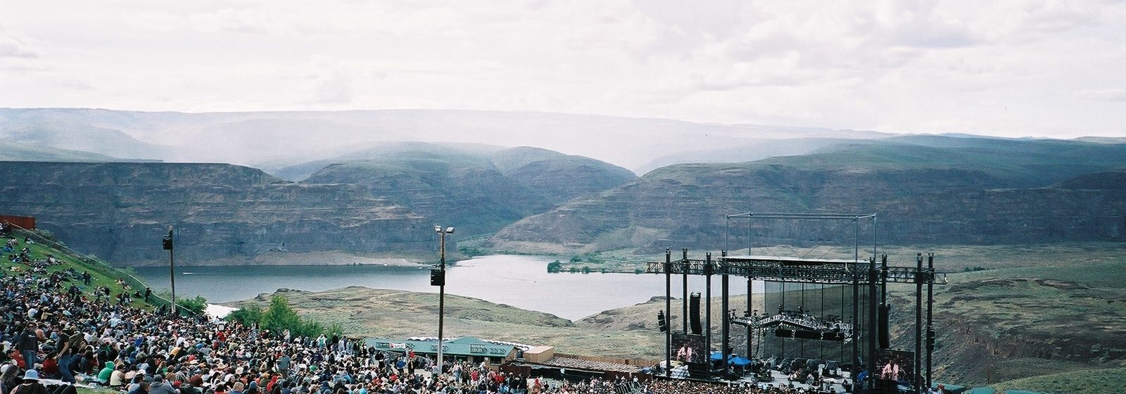 Wide view of the Gorge Amphitheatre's terraced lawn bowl near Quincy, Washington, with the stage overlooking the Columbia River gorge during a 2006 festival - Gorge Amphitheatre tickets
