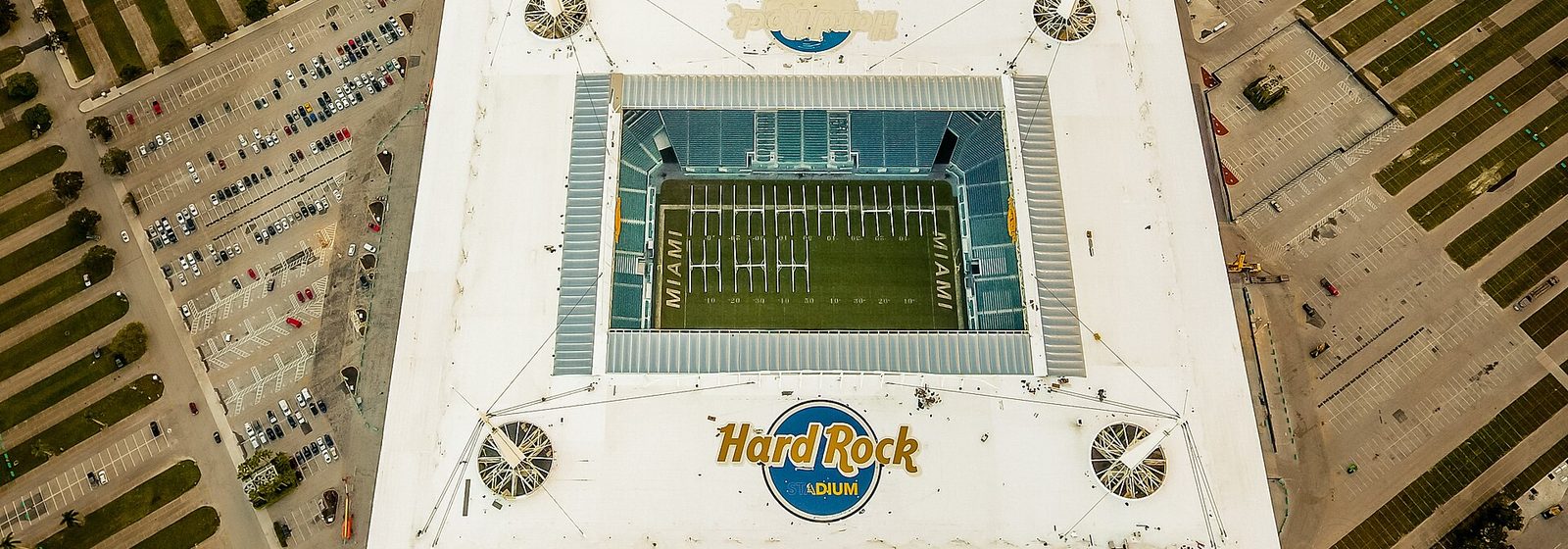 Aerial view of Hard Rock Stadium and its white canopy roof, surrounded by parking lots in Miami Gardens, Florida - Hard Rock Stadium tickets