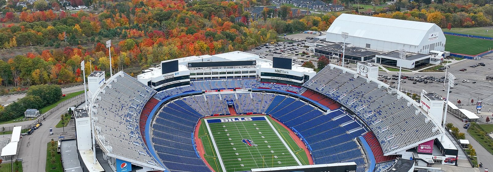 Aerial view of Highmark Stadium and its open seating bowl in Orchard Park, New York, surrounded by autumn foliage - Highmark Stadium tickets