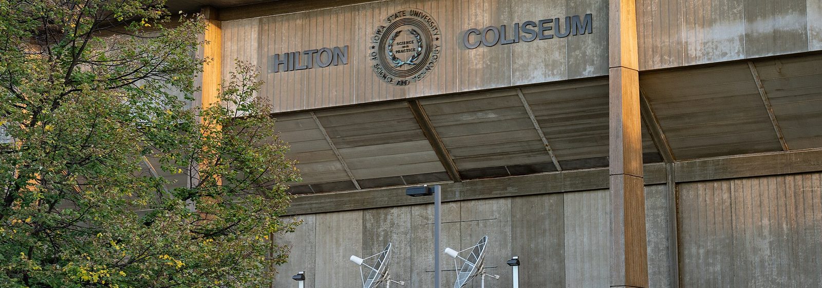 Exterior facade of Hilton Coliseum at Iowa State University in Ames, Iowa, with the venue's name lettering above the entrance - Hilton Coliseum tickets