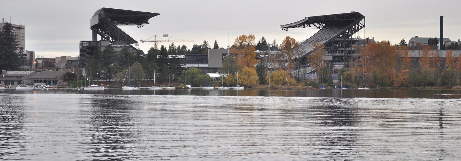 Exterior view of Husky Stadium at the University of Washington in Seattle, seen across the water from Foster Island in the Washington Park Arboretum - Husky Stadium - WA tickets