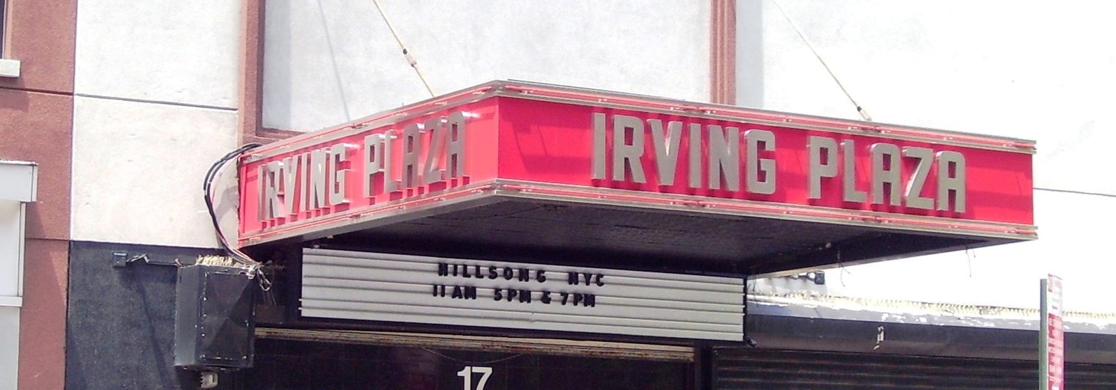 Street-level view of the red Irving Plaza marquee over the venue entrance at 17 Irving Place in Manhattan, New York City - Irving Plaza tickets