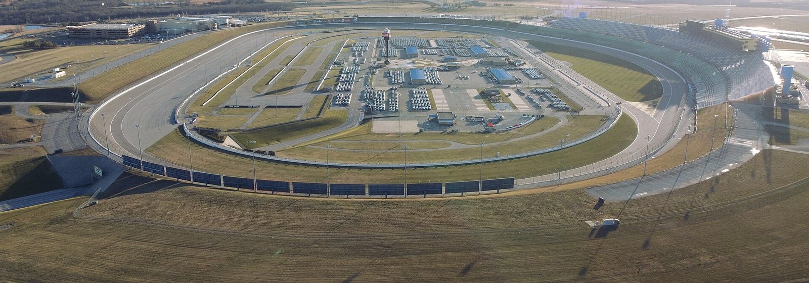 Aerial view of the Kansas Speedway tri-oval track, infield, and grandstands in Kansas City, Kansas - Kansas Speedway tickets